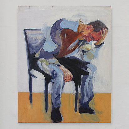 seated man with hand on head